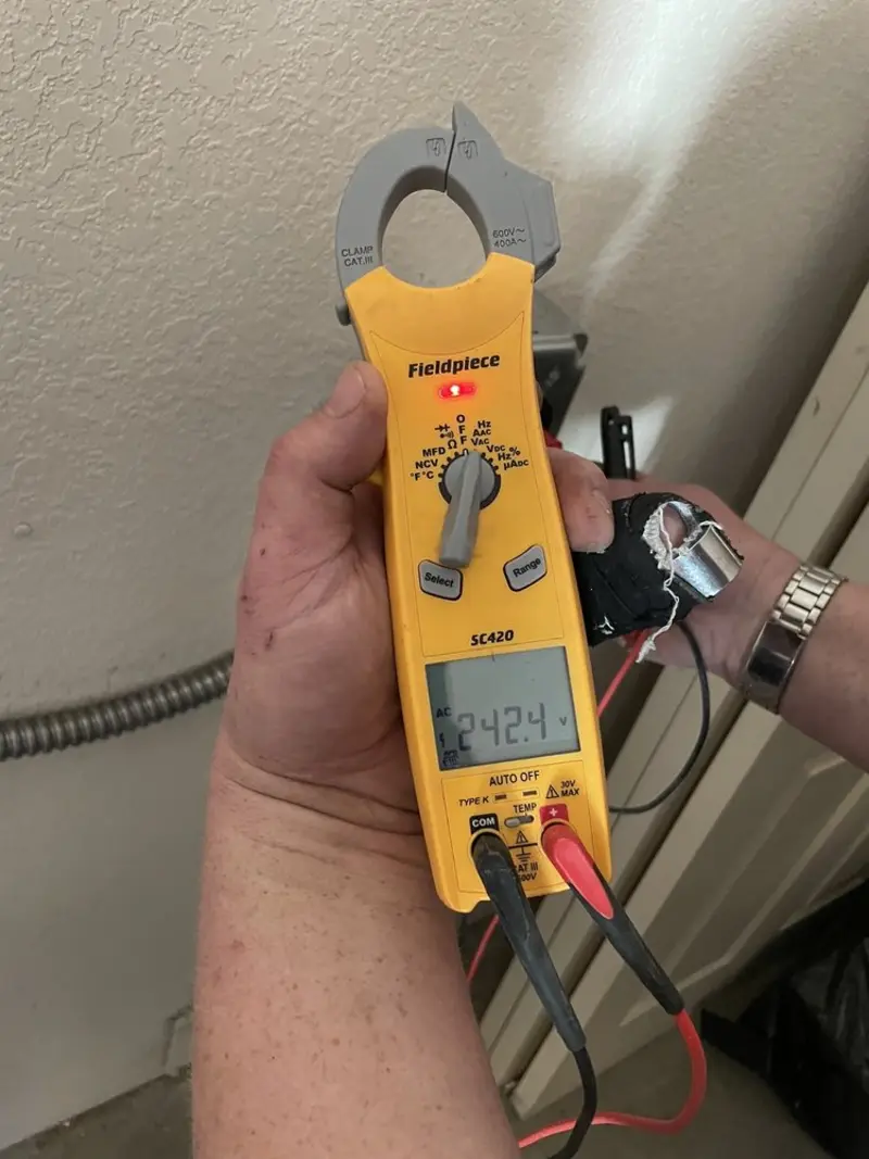 Voltage testing with clamp meter during Recessed Lighting Installation in Payette